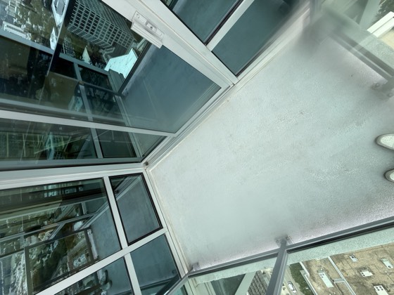Balcony after cleaning &mdash; corners and edges cleared, the floor surface an even tone.