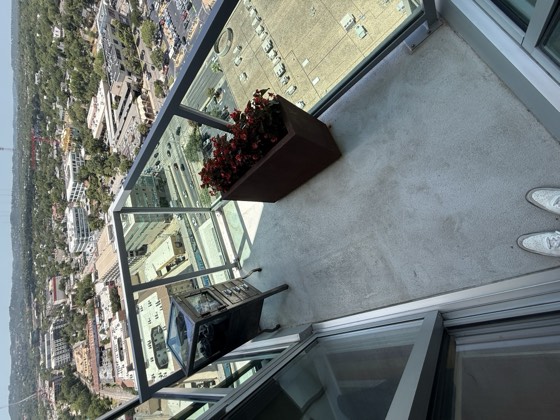Balcony after cleaning &mdash; the ring stains and dirt removed, concrete back to an even light grey.