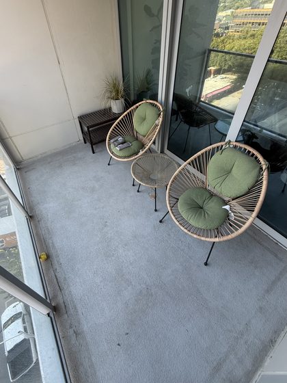 Balcony before cleaning &mdash; grey grime film and scuff marks across the floor.